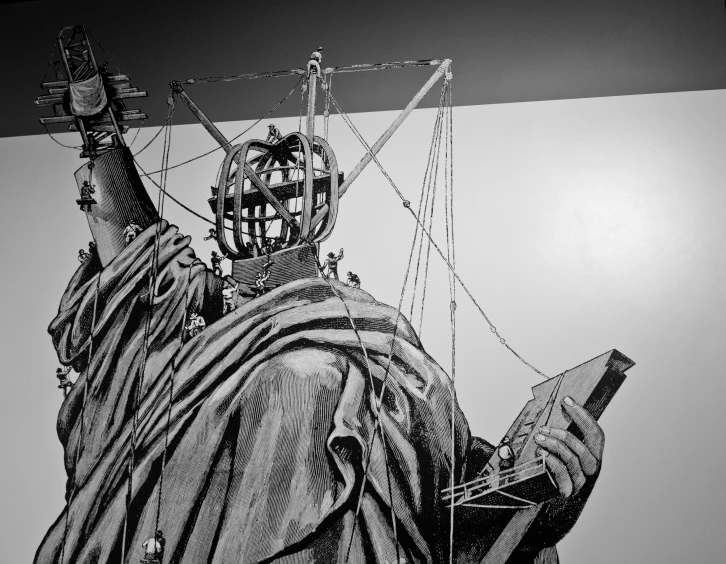 a statue of liberty is shown against a wall