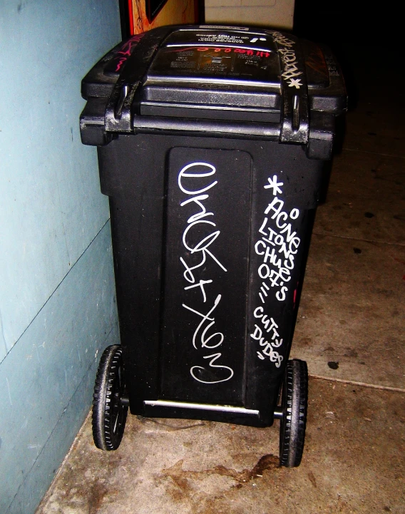 a trash can with graffiti written on it