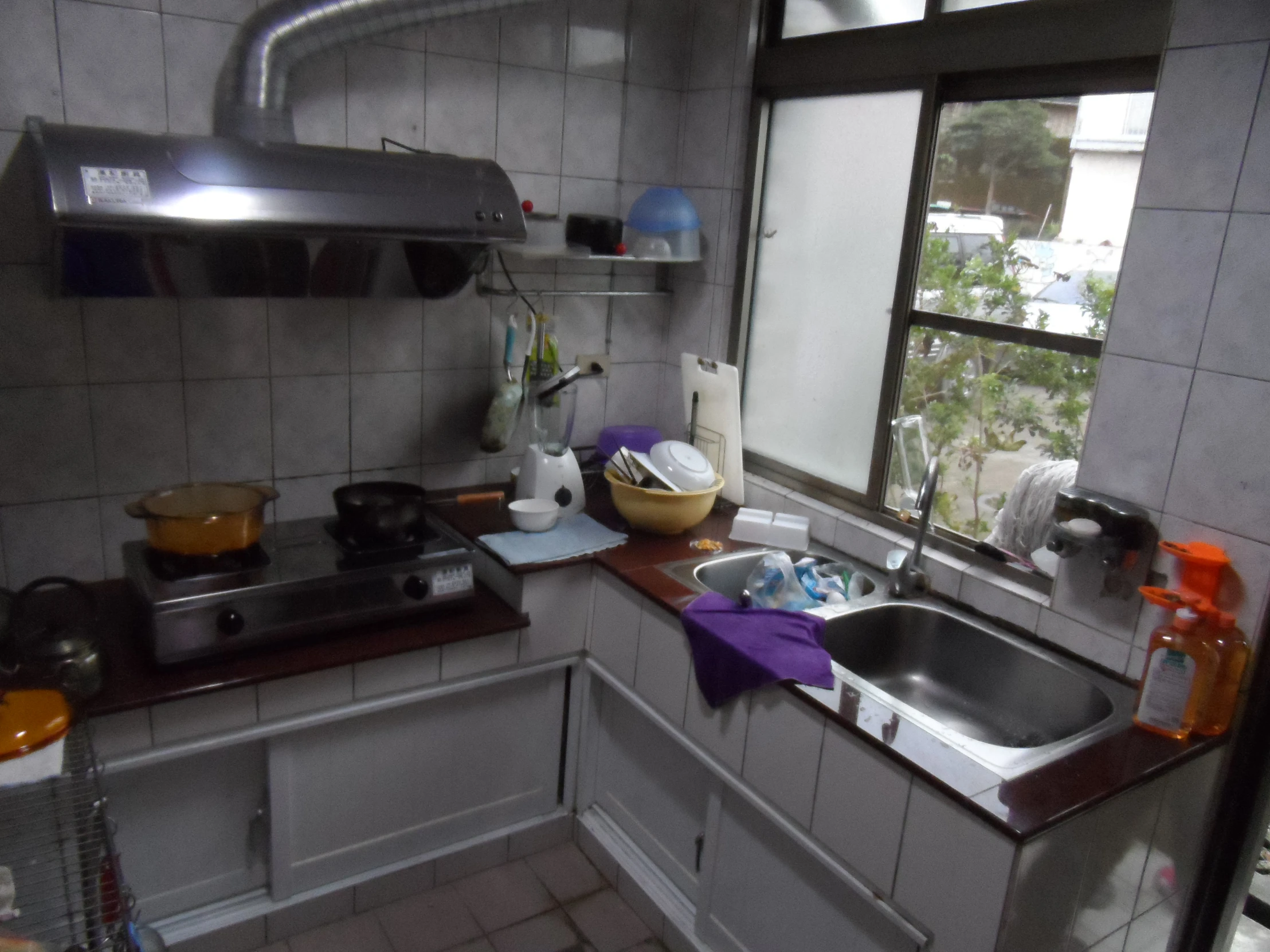 a kitchen has a sink, stove and window