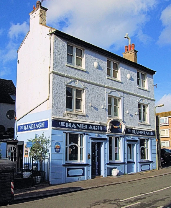 a blue and white building with a brick chimney