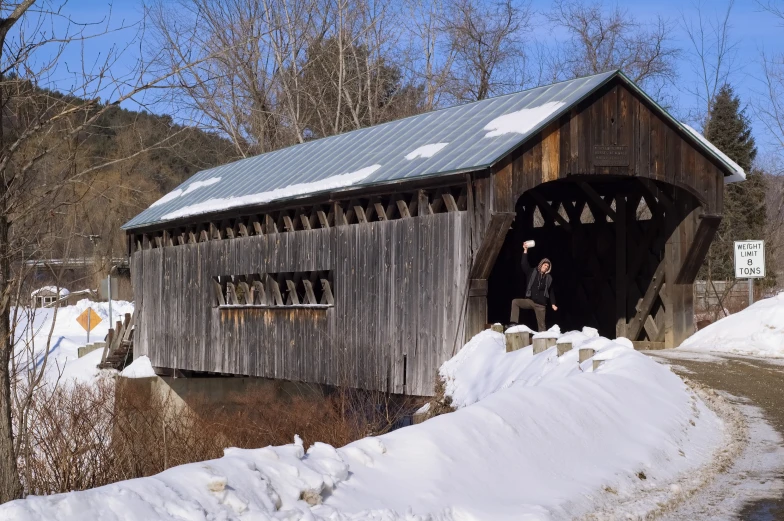 an old covered bridge with the light on