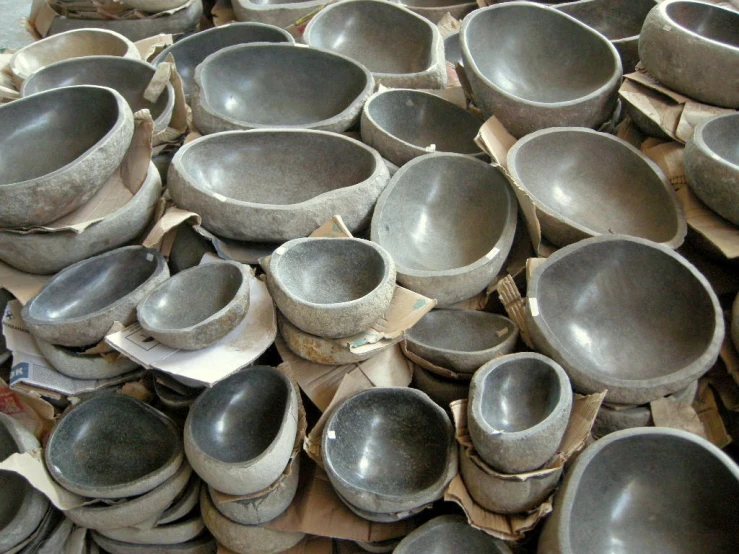 there is many gray bowls stacked together