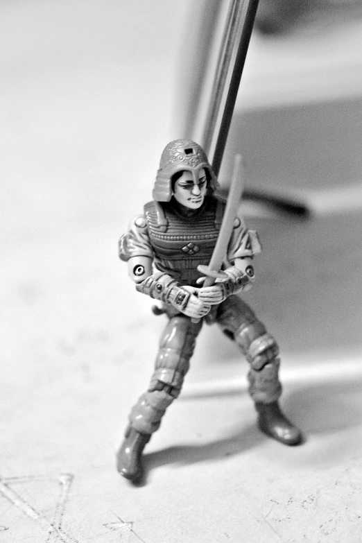 a figurine of a character in a space suit holding a sword