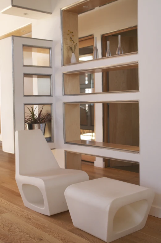 modern daybed chair in front of an area with built - in shelving