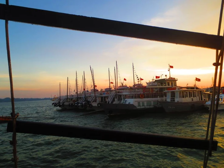 several ships parked on the docks in the water