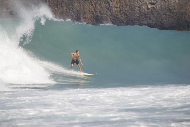 the surfer in trunks and  is riding a wave