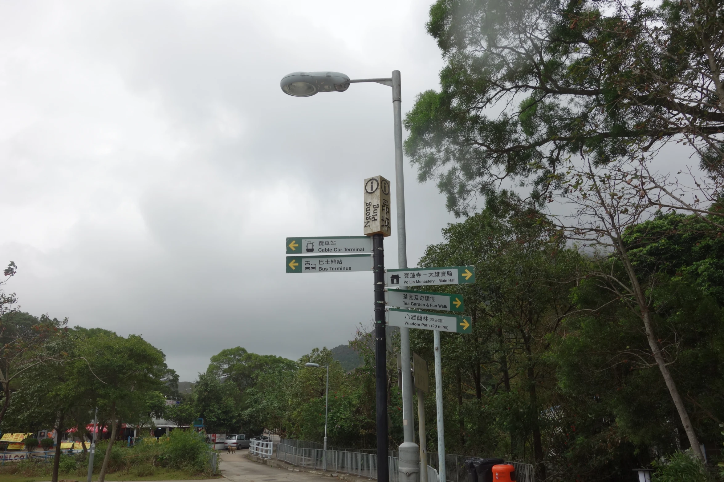 a few street signs that are on a light pole