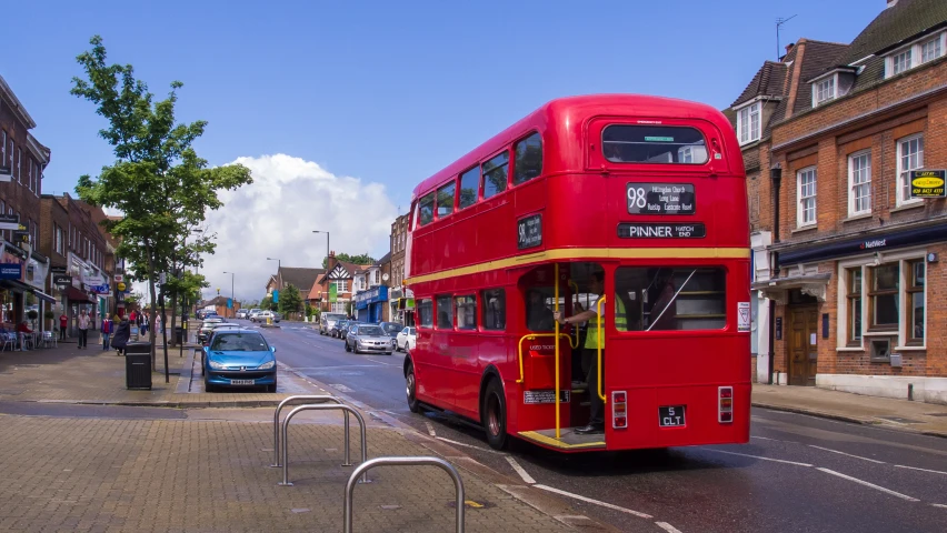 a double decker bus rides down the road