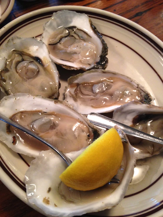 a plate with sliced oysters on a table