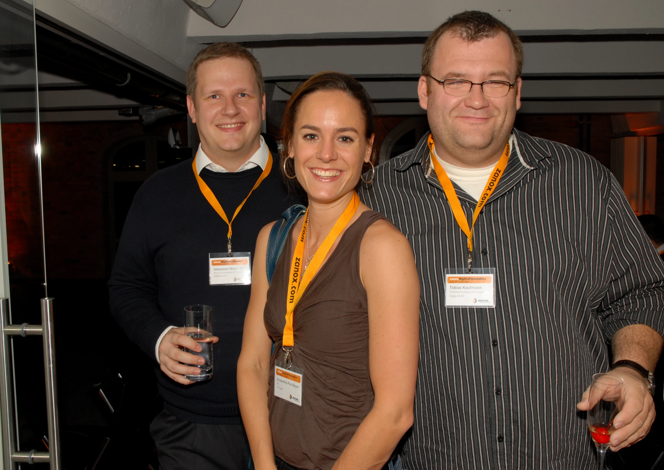 there are three people smiling and posing together