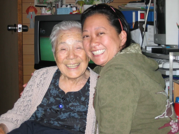 a woman and an older women are smiling for a po