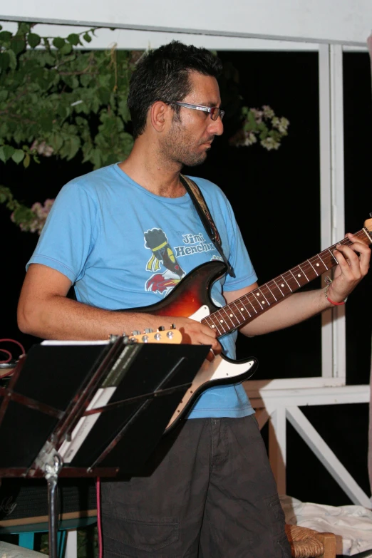 a man playing the guitar while playing the music instrument