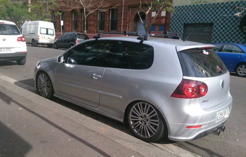 a silver car with its roof mounted to the back of it