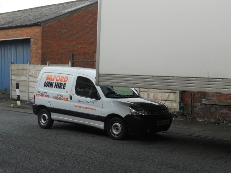 a van parked in front of a brick building