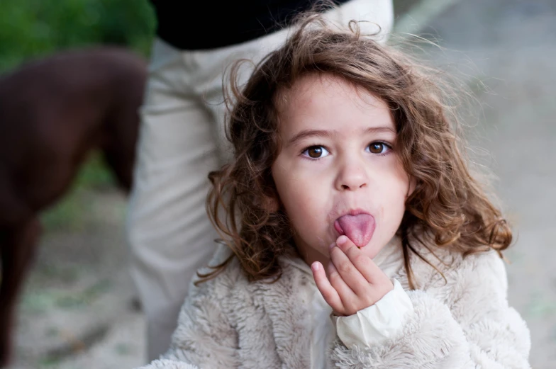 the girl has her fingers under her mouth