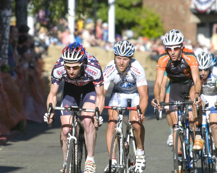 people riding on bicycles down the road during a competition