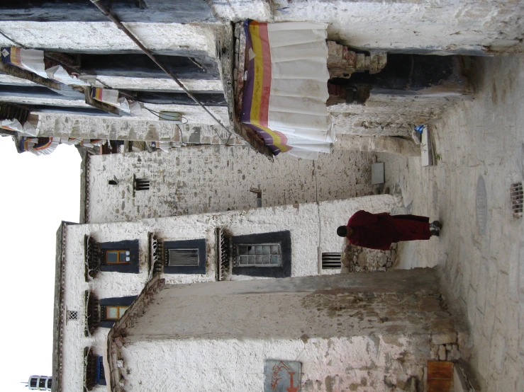 the monk in a robe is walking down the street