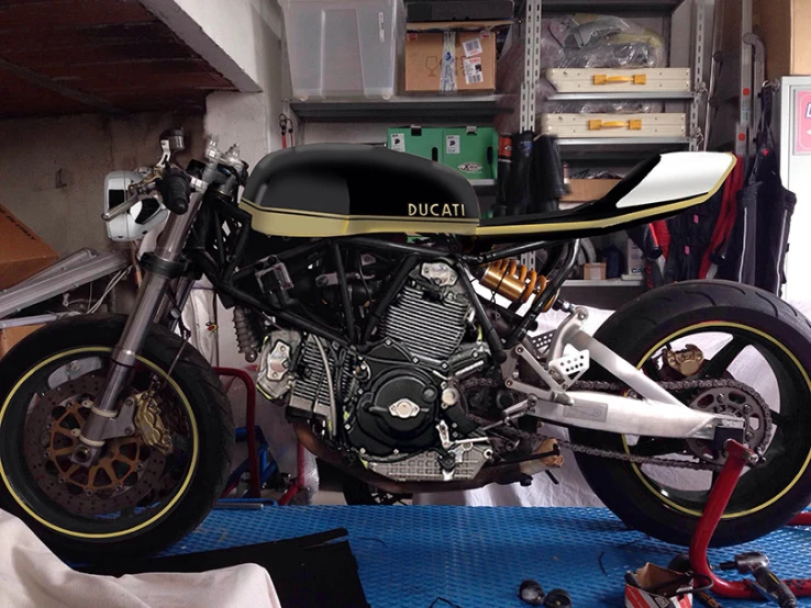 a motor bike sitting in the workshop with other equipment