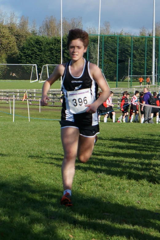 a man in a running outfit jogging down a track