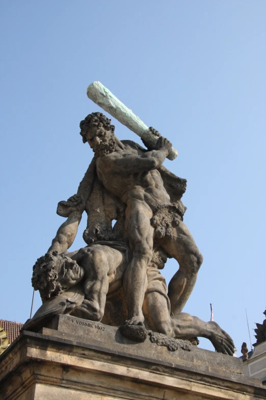 a statue on top of a building with a bat