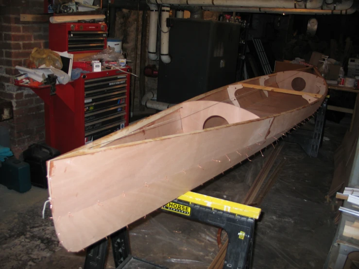 a boat being made in the workshop of an automotive repair shop