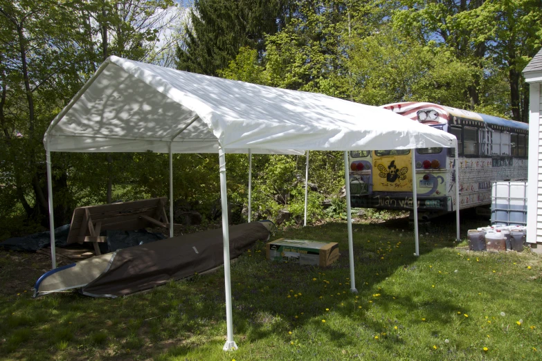 a canopy that is covering a building in the grass