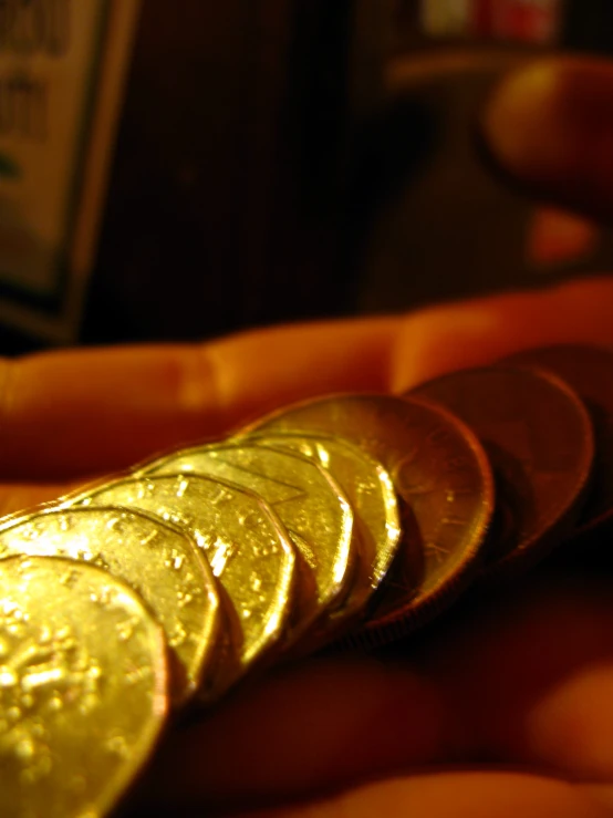 several coins that are in the palm of a persons hand