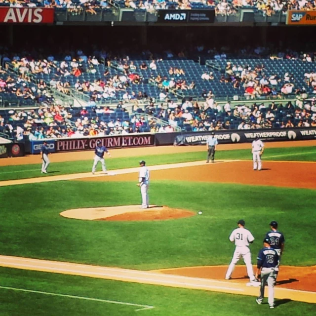 a group of people are watching a baseball game