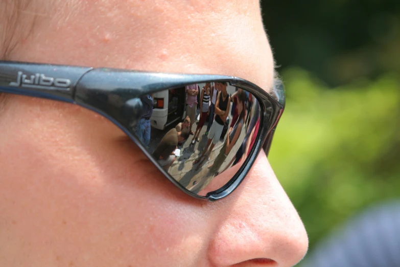 the side view of a woman wearing a pair of sunglasses