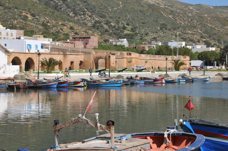 a group of boats parked near a city