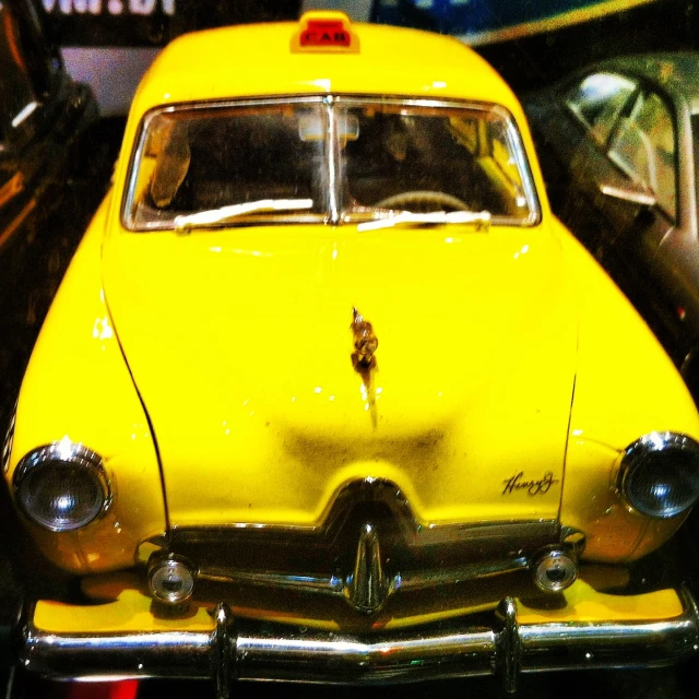 a yellow toy car is shown in an auto show