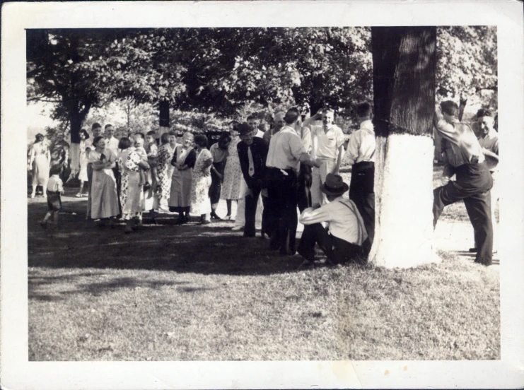 an old po shows people gathered in the park