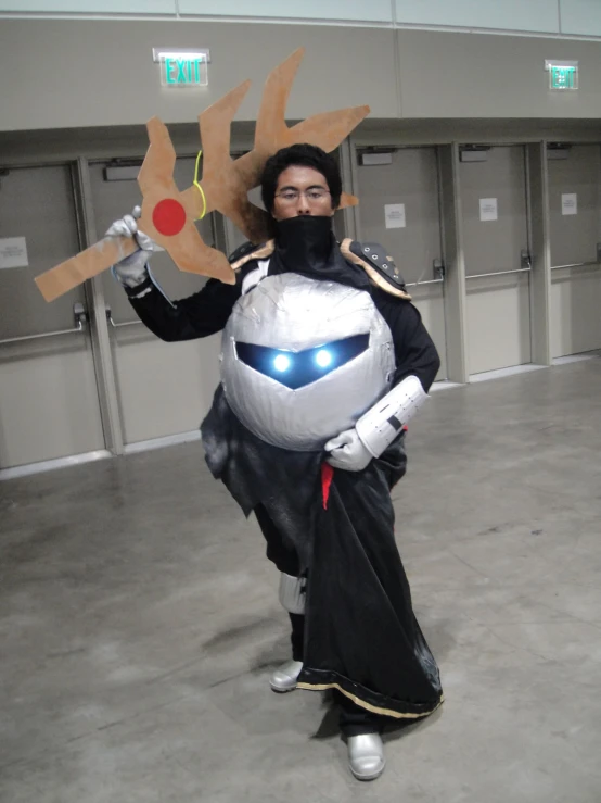 a man in armor holding a giant pair of scissors