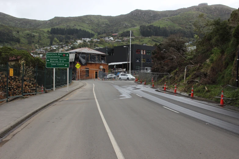 a view down a road that has buildings in the background