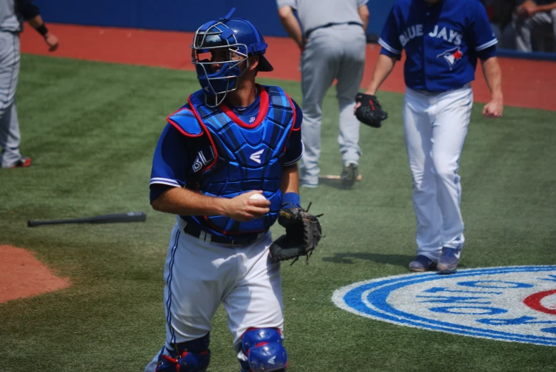 players in blue and white uniforms walking around on the field