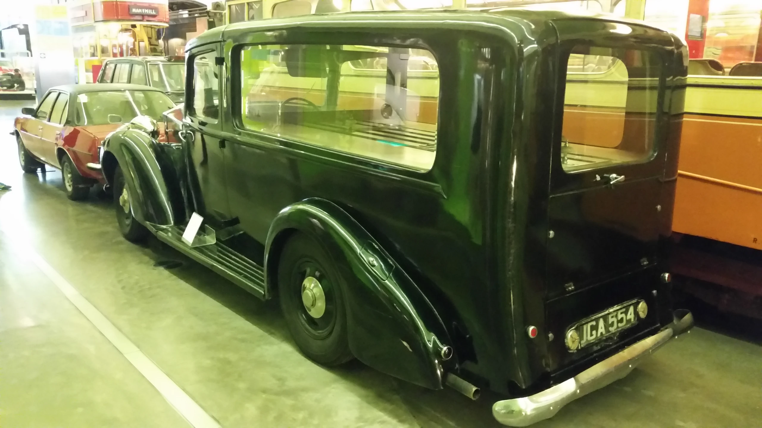 an old classic car in a showroom during the day