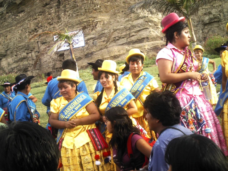 women in costumes and hats, standing with banners