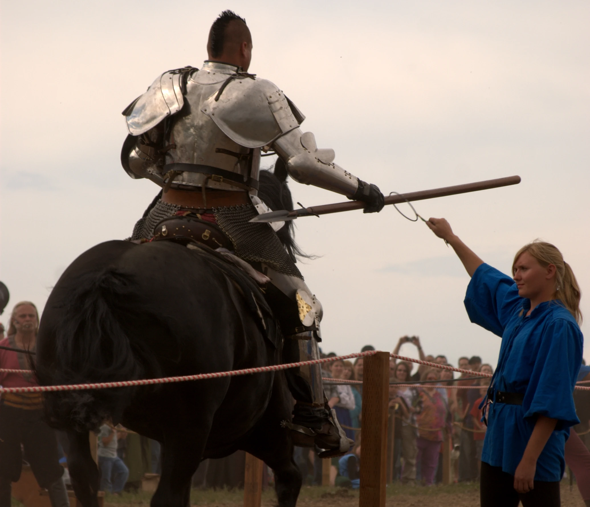 the woman is pointing at the mounted knights