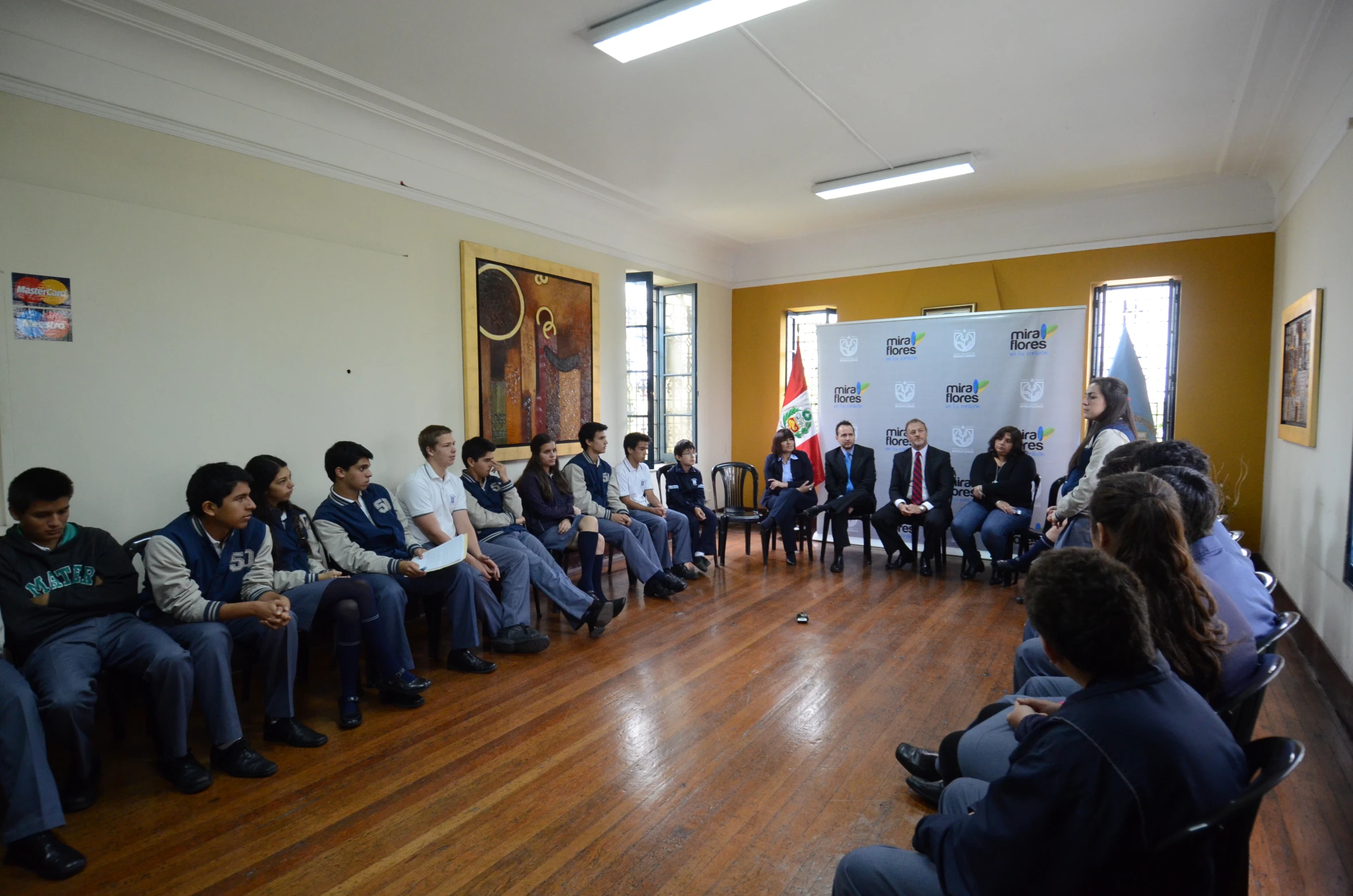 a group of people sitting on different seats watching a man speak