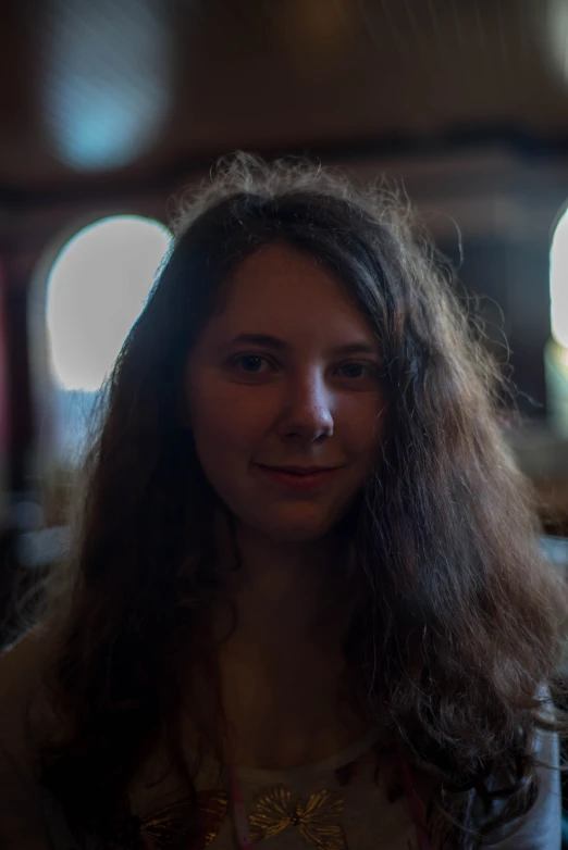 a young woman is smiling at the camera