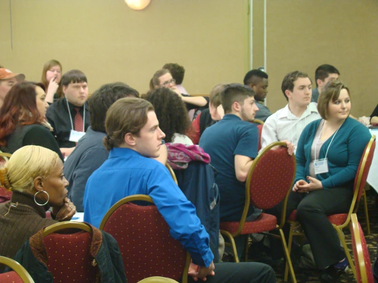 a group of people sitting and talking to each other