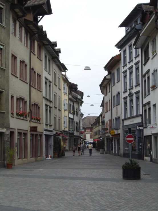 several buildings are on the street next to a man walking