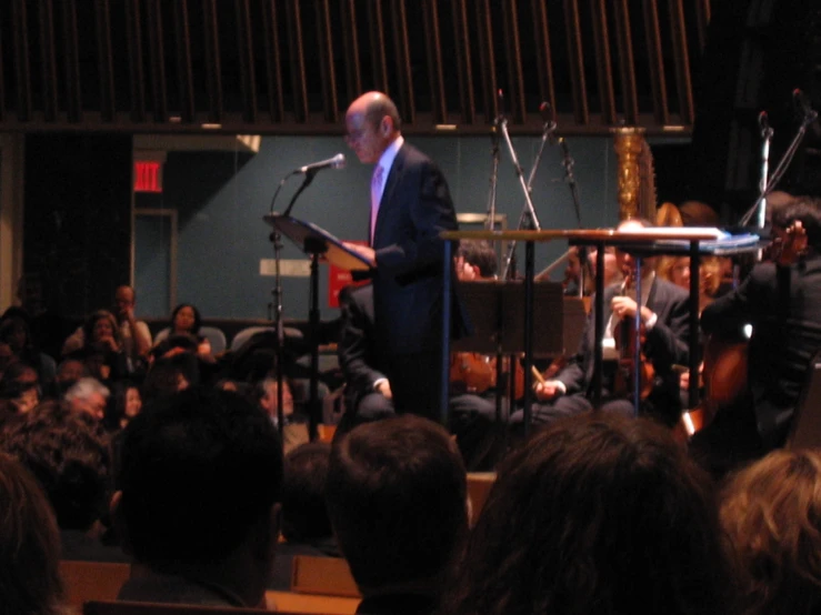 a man standing at the front of a room in front of an audience