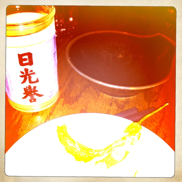 a small plate sitting on a table near a container with writing on it