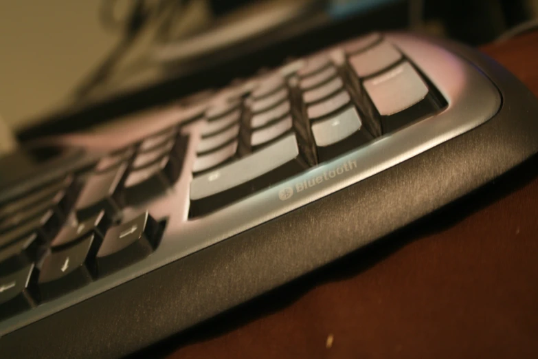 the keyboard of a computer sits on a desk