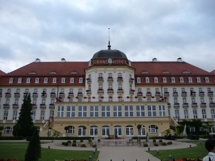 a very large, pretty building next to a building that has flowers on the windows