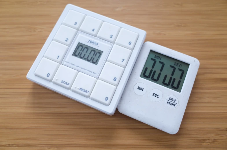 a white timer on top of a wooden table