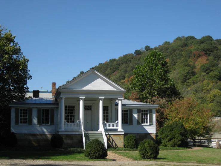 the large house sits in front of a very tall mountain