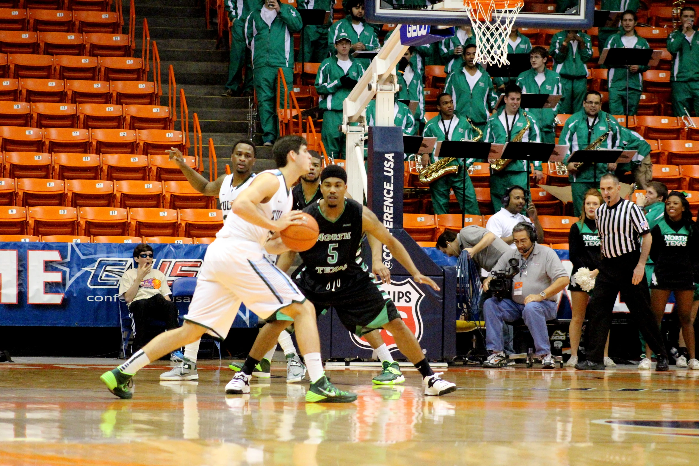 a group of men playing basketball in a game