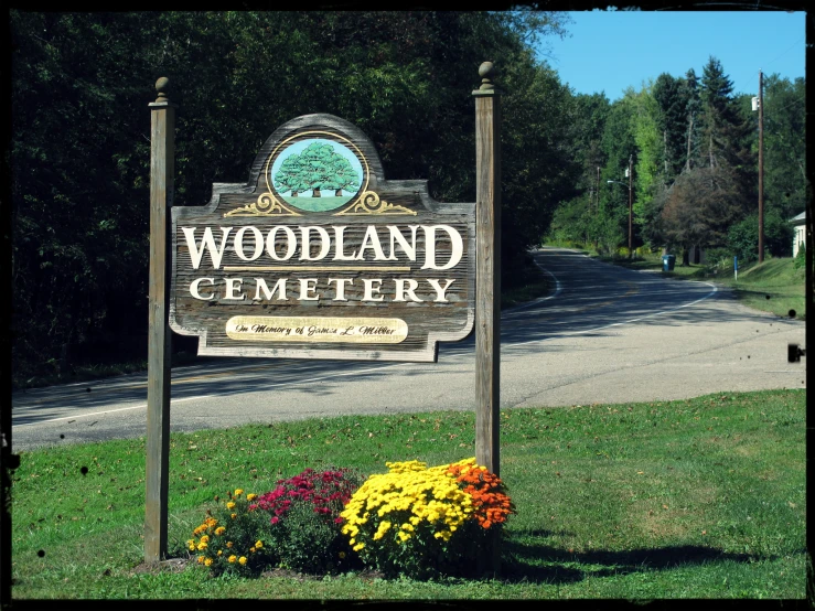 this is a sign for the entrance to woodland cemetery